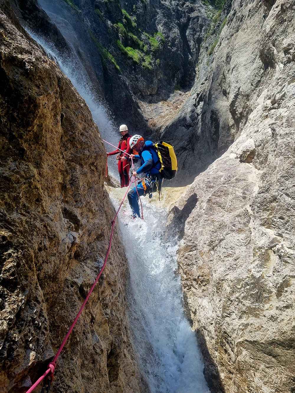 Paul guiding clients down a waterfall during canyoning in Fischbachklamm. Canyoning in Salzburg with Paul Murray. Guided Canyoning Tours for small groups only.