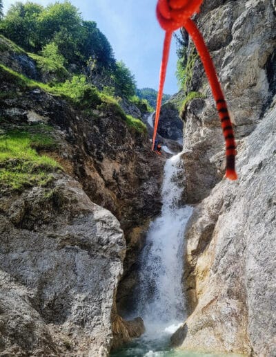 Thrilling ziplining through a waterfall in Fischbachklamm, Bluntautal, Salzburg - a unique adventure experience. Fischbachklamm - Bluntautal - Canyoning in Salzburg mit Paul Murray.